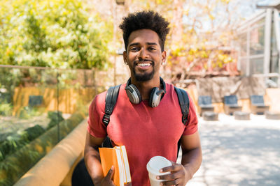 Portrait of smiling young man drinking drink