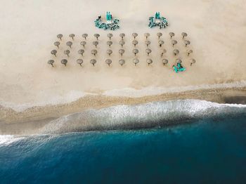 Aerial view of an empty beach and beach umbrellas