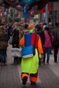Group of people walking in multi colored city