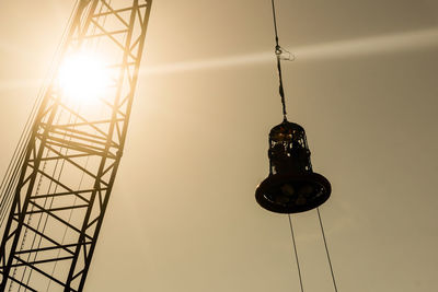 Low angle view of illuminated electric lamp against sky