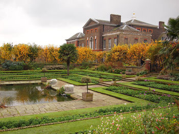 Scenic view of lake and buildings against sky