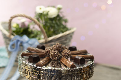 Close-up of red chili peppers in basket on table