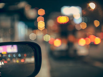 Close-up of illuminated lighting equipment on street in city