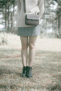 Low section of woman standing on ground