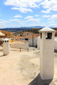 Buildings in town against sky