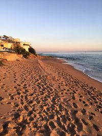 Scenic view of beach against clear sky