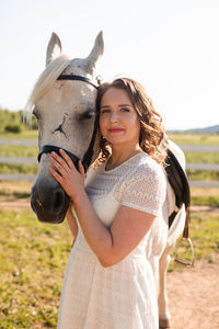 Beautiful young woman standing on land