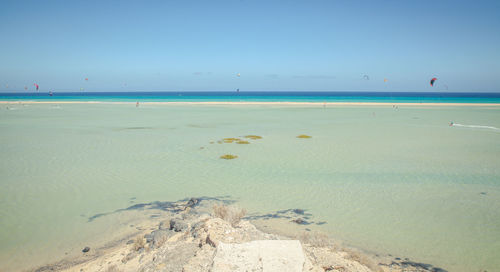 Scenic view of beach against clear sky