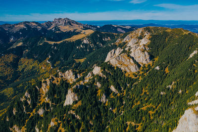 Scenic view of land and mountains against sky