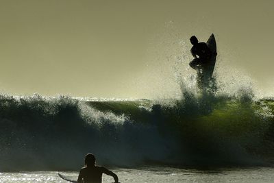 Two people surfing in the sea