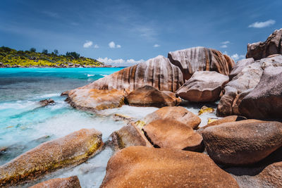 Rocks on beach against sky