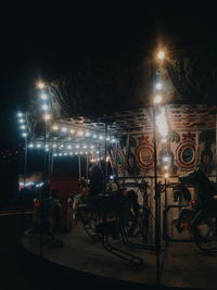 People on illuminated stage at night