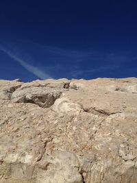 Low angle view of mountain against blue sky