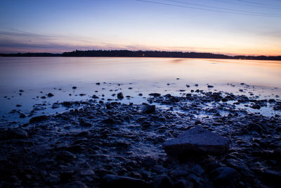 Scenic view of lake against sky during winter