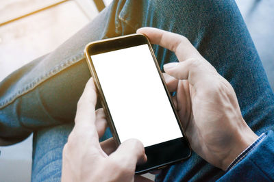 Midsection of man using mobile phone