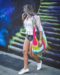 Full length of woman walking by staircase