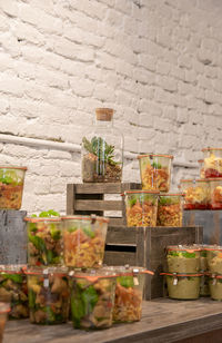 Potted plants in container against wall