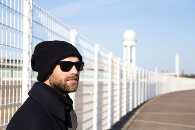 Portrait of man standing in city