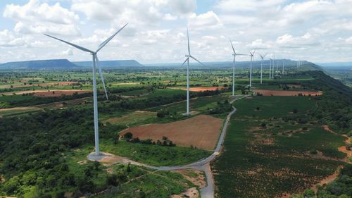 Wind turbine farm power generator in beautiful nature landscape for production of green energy 