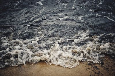 High angle view of waves reaching shore at beach