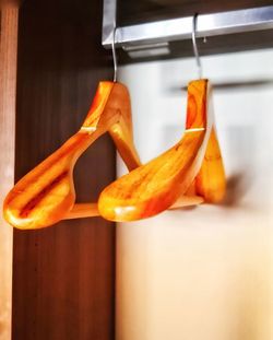 Close-up of orange fruits hanging on wood