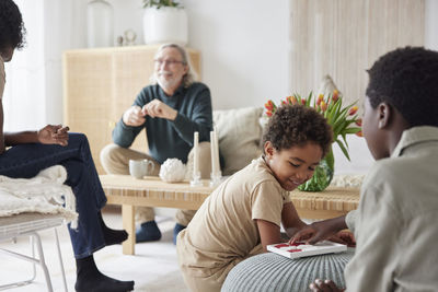 Family relaxing and playing games at home