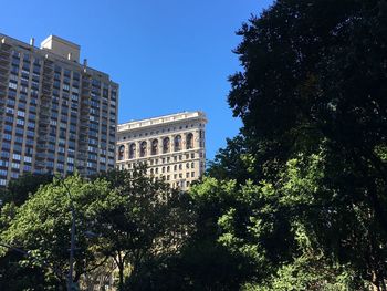 Low angle view of buildings against blue sky