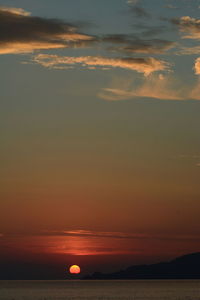 Scenic view of sea against romantic sky at sunset