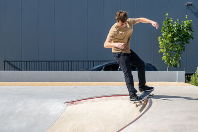 Full length of young man exercising on street