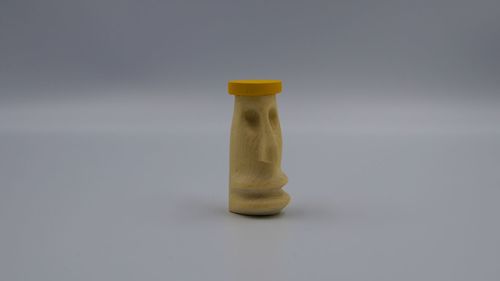Close-up of glass bottle on table against white background
