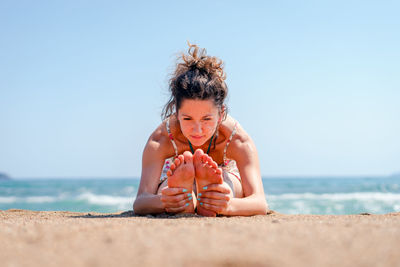 Full length of boy on beach against sky