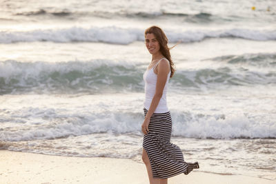 Young woman standing on beach