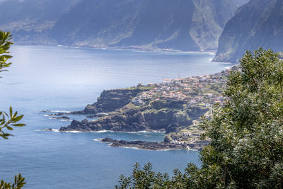 High angle view of houses on cliff by sea