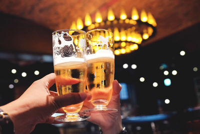 Cropped hands of people toasting drinks