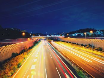 High angle view of light trails on road at night