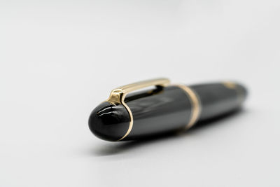 Close-up of eyeglasses on table against white background