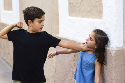 Boy fighting with girl outdoors