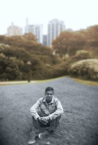 Portrait of man sitting in city