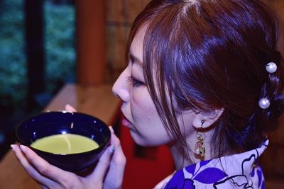 Portrait of woman drinking drink