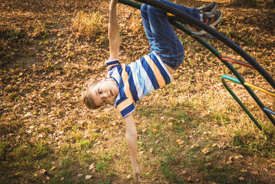 High angle view of boy playing with jungle gym in park