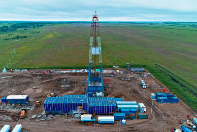 High angle view of cranes on field against sky