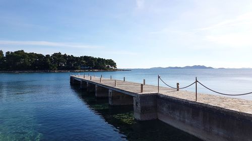 Scenic view of swimming pool by sea against sky