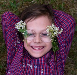 Portrait of a smiling boy with flowers