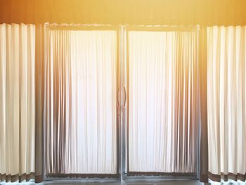 Close-up of curtain against window at home