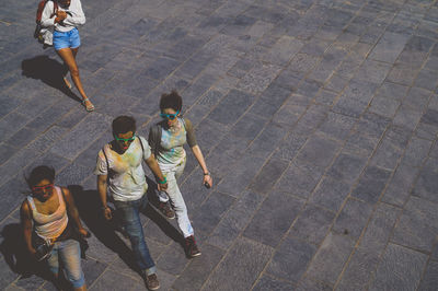 High angle view of people walking on footpath
