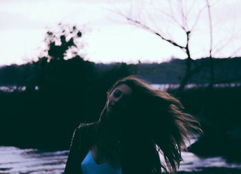 Close-up of young woman against water