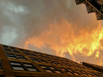 Low angle view of building against cloudy sky