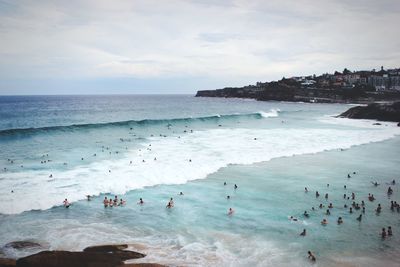 High angle view of people enjoying at beach