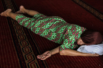 Midsection of man lying on floor