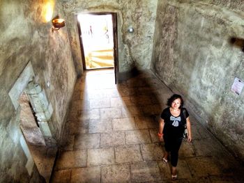 Portrait of smiling woman walking in old ruin